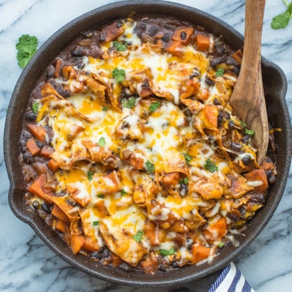 Stove Top Sweet Potato & Black Bean Enchilada Casserole in a skillet topped with cilantro