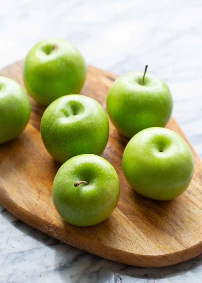 green apples on a cutting board