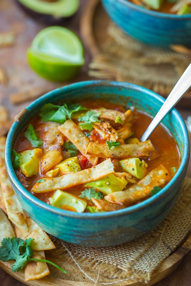 instant pot chicken tortilla soup in a green bowl topped with avocado and cilantro