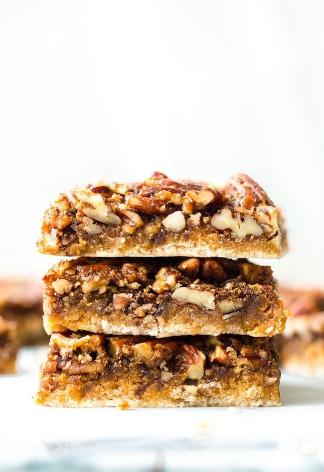 paleo vegan pecan pie bars stacked on top of each other
