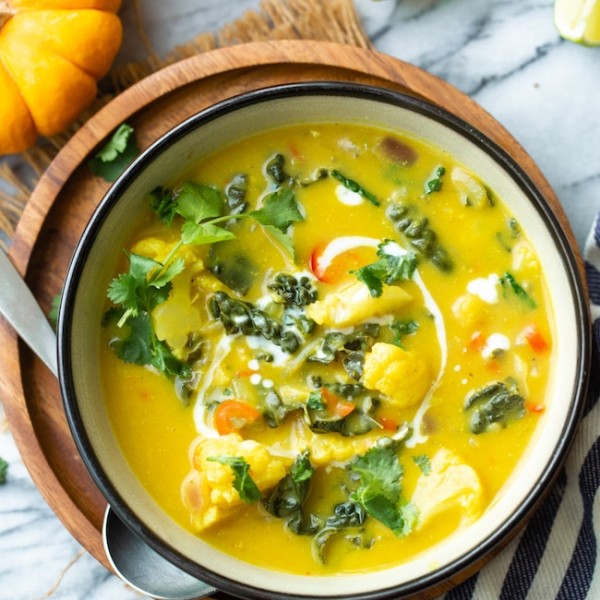 thai pumpkin soup in a bowl topped with cilantro