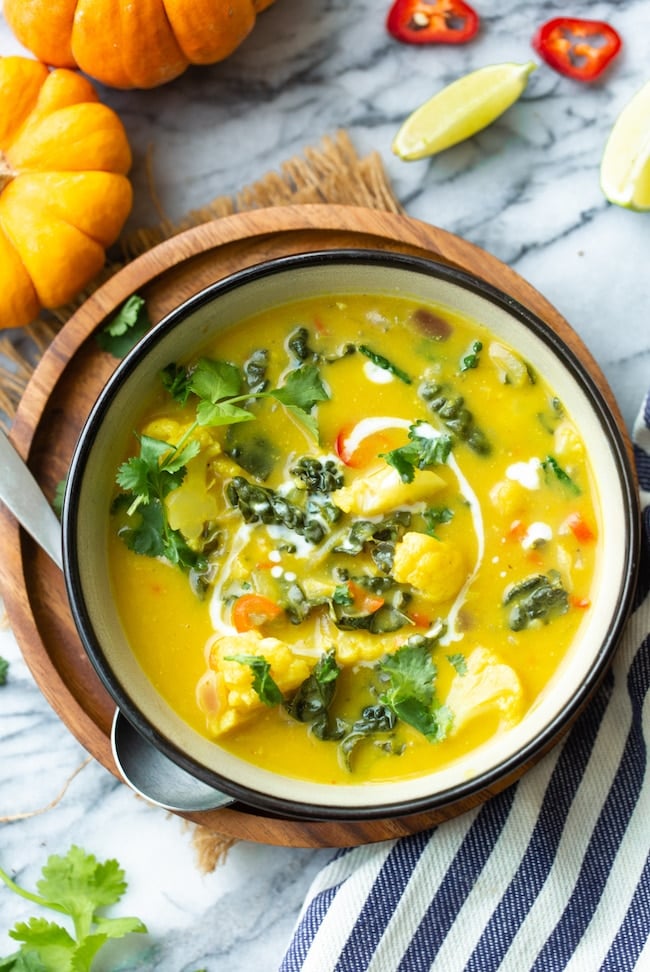 thai pumpkin soup in a bowl topped with cilantro 