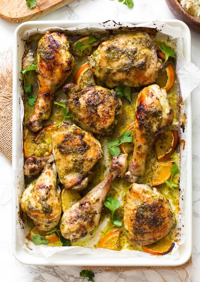 Herby One Pan Chicken with Oranges on a sheet pan topped with cilantro 