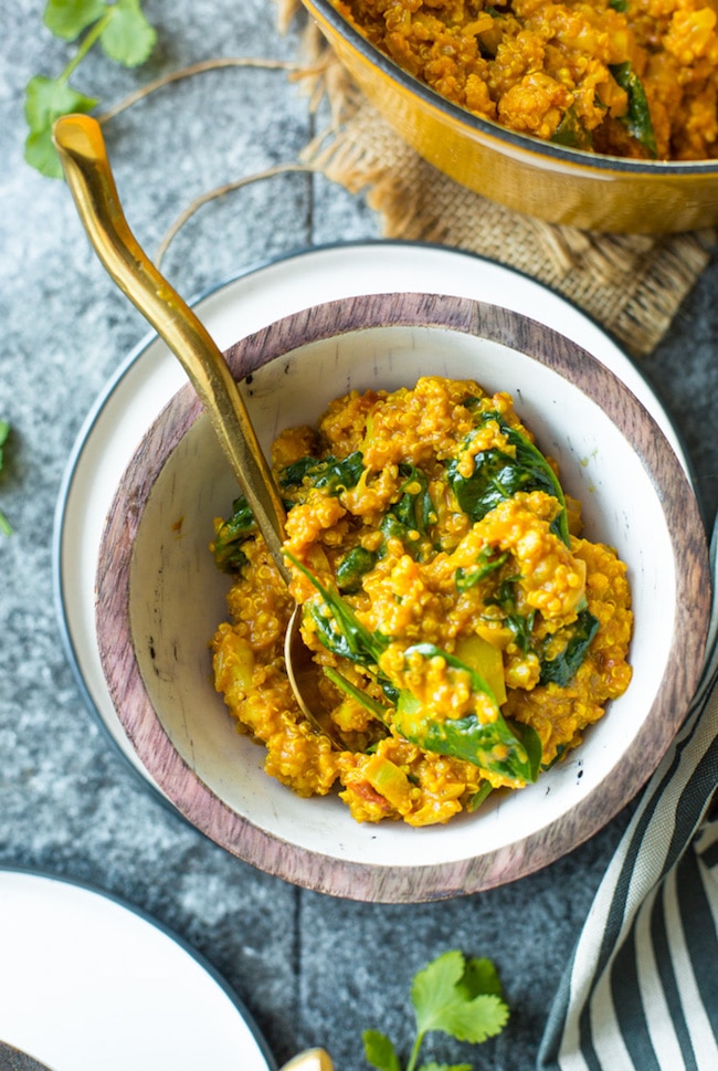 Golden Cauliflower Quinoa Curry in a bowl with a spoon