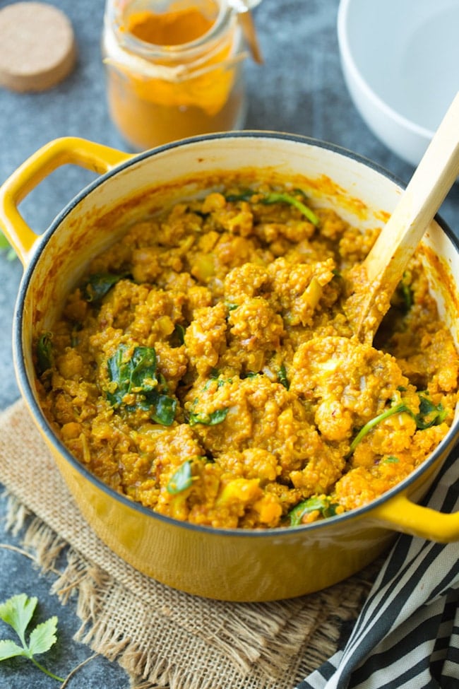 Golden Cauliflower Quinoa Curry in a pot topped with cilantro