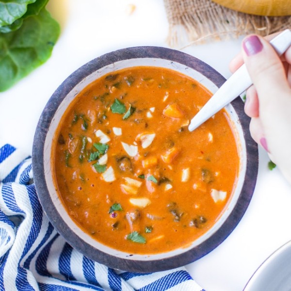 One Pot African Peanut Soup in a bowl topped with peanuts and cilantro