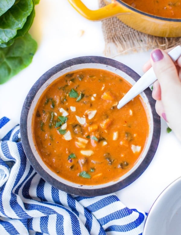 One Pot African Peanut Soup in a bowl topped with peanuts and cilantro