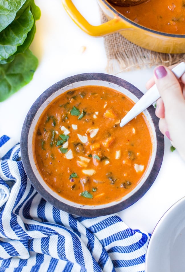 One Pot African Peanut Soup in a bowl topped with peanuts and cilantro