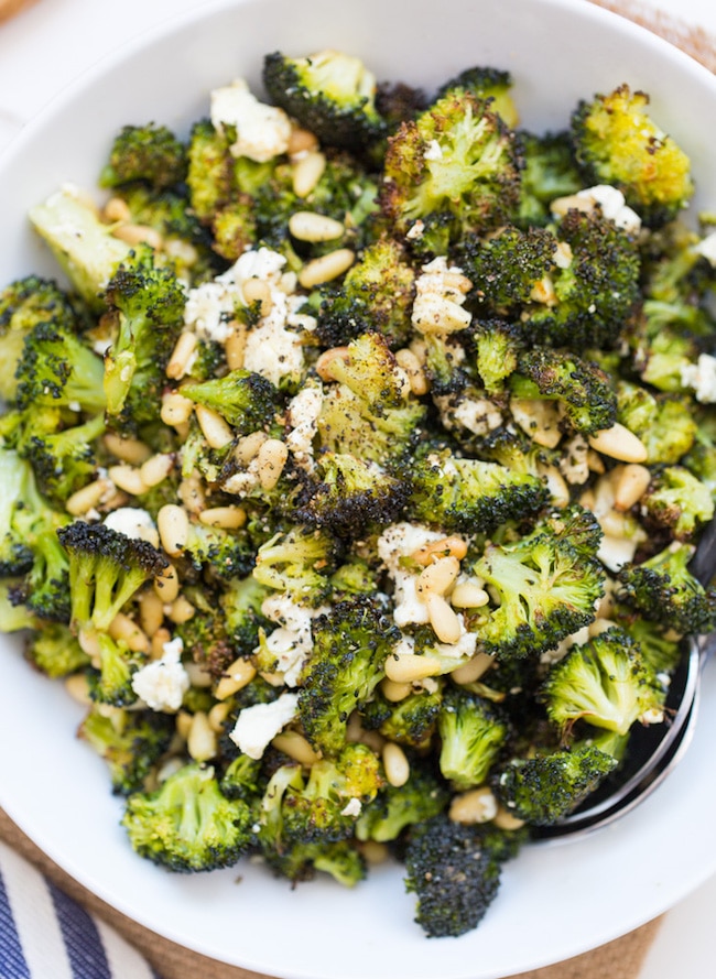 Roasted Broccoli Salad with Feta and Pine Nuts in a bowl topped with feta and pine nuts