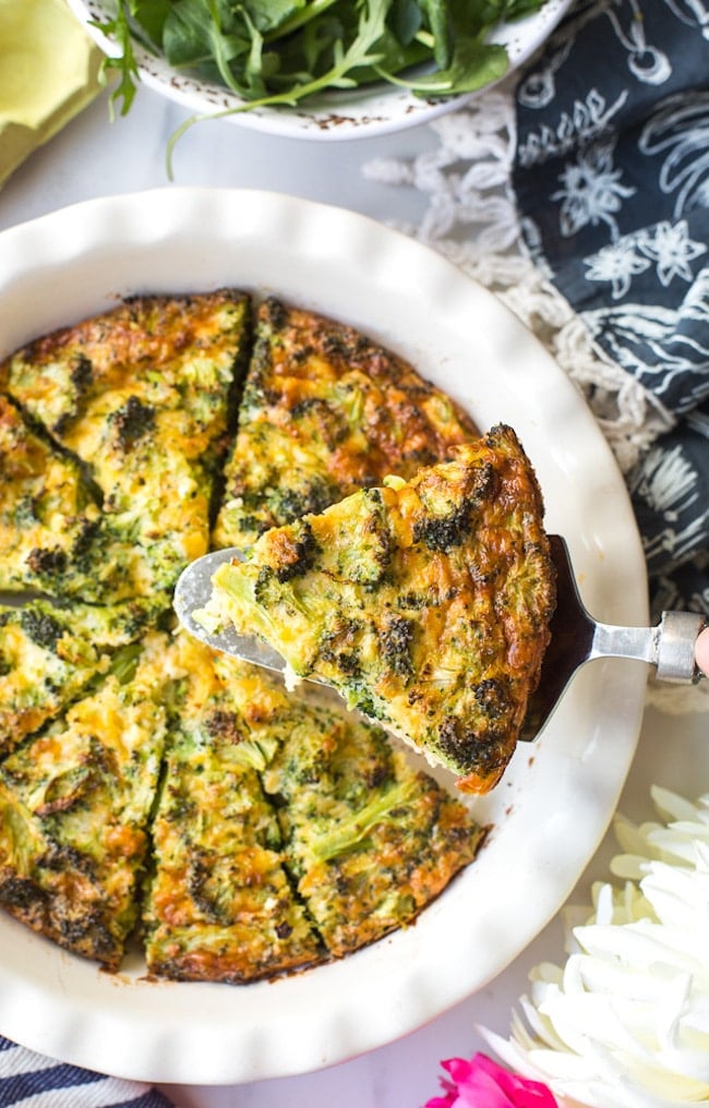 Broccoli Cheddar Crustless Quiche with a slice held up