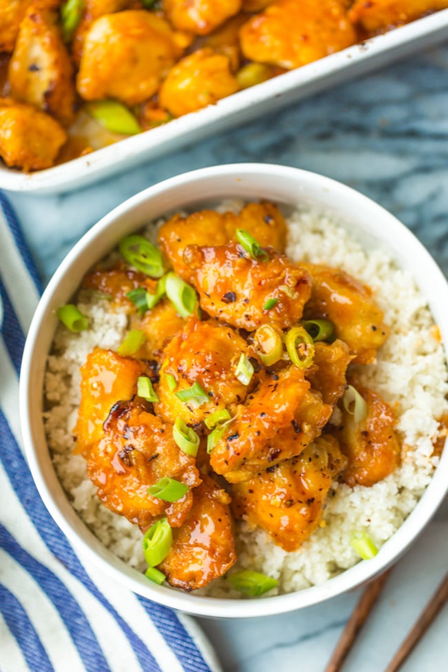 paleo firecracker chicken in a bowl with cauliflower rice 