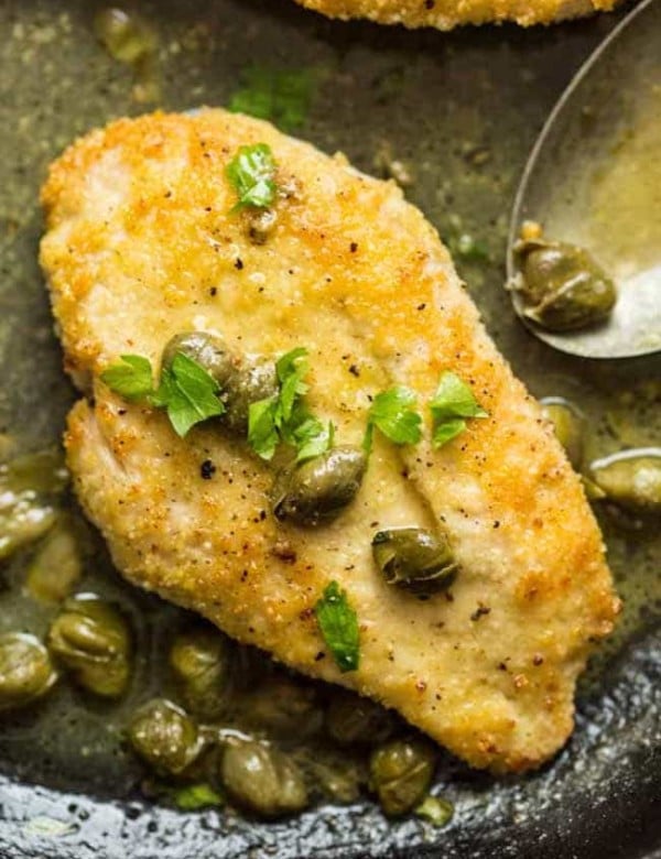 lemon caper chicken in a cast iron skilet