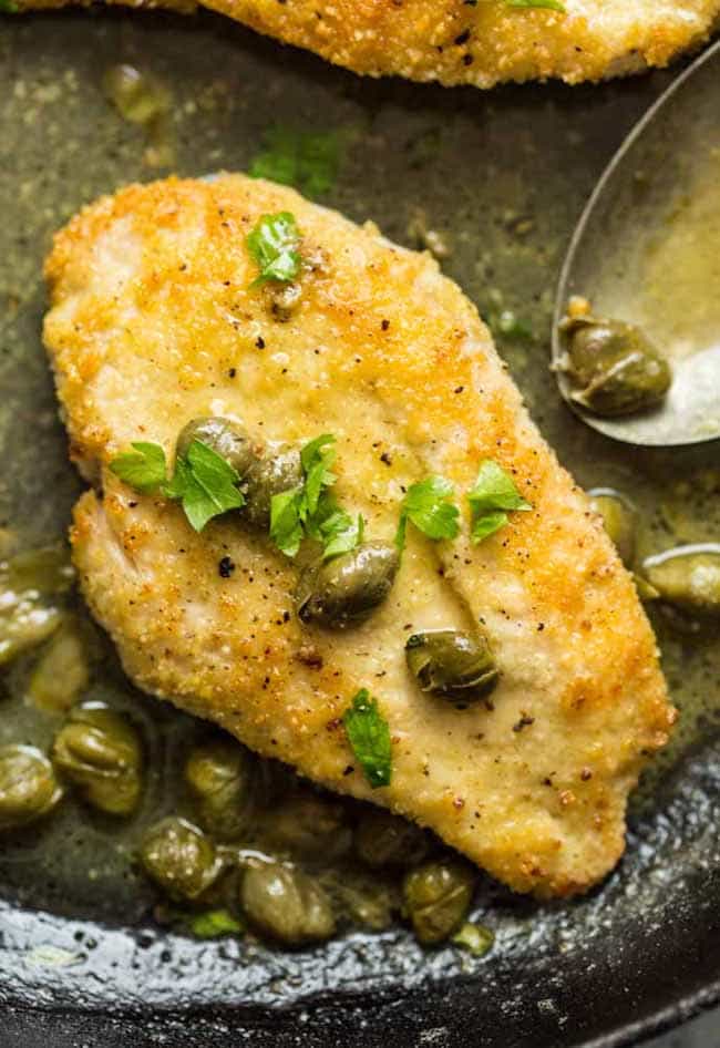 lemon caper chicken in a cast iron skilet