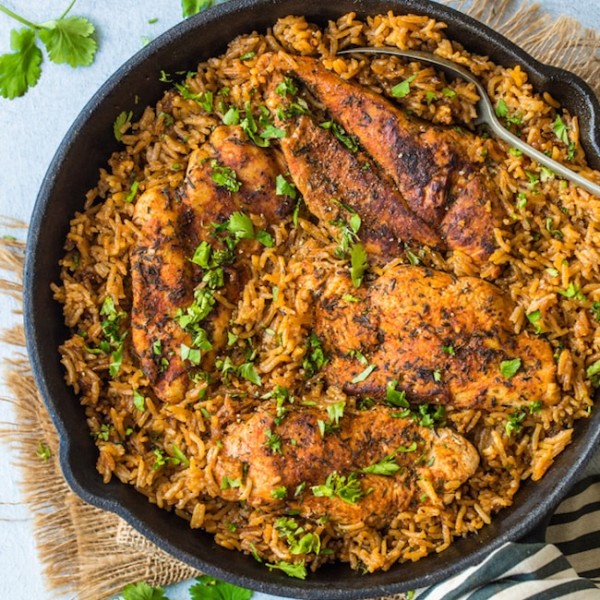 one pot chicken and rice in a cast iron skillet