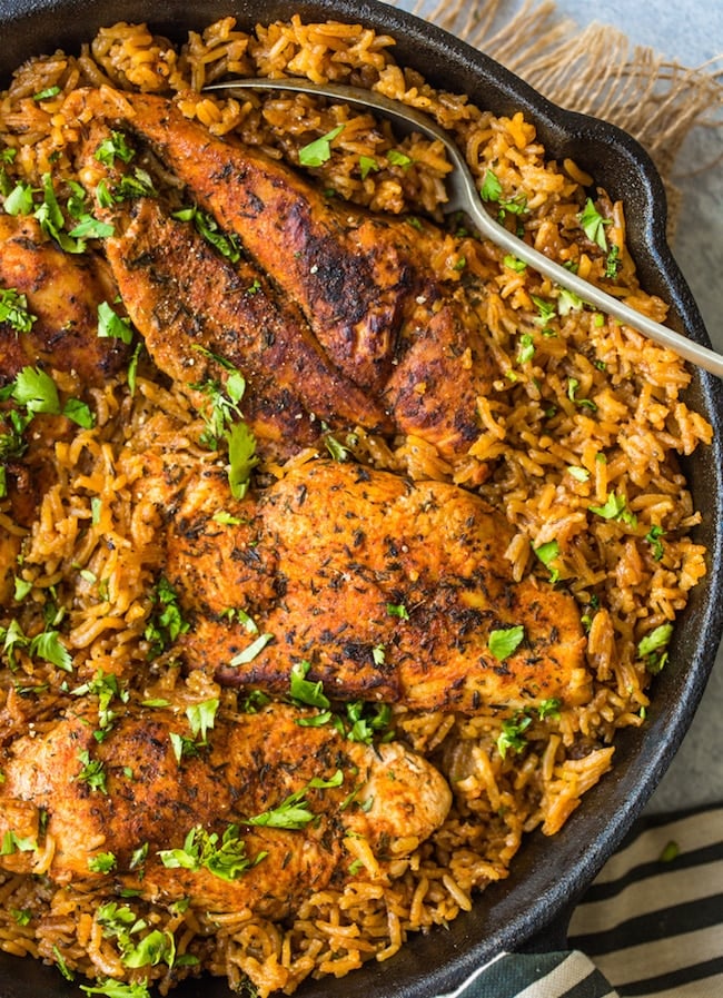 One Pot Chicken and Rice topped with chopped cilantro in a cast iron skillet up close