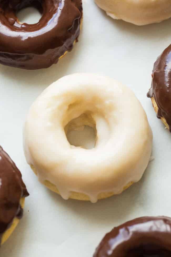 chocolate and vanilla baked gluten free donuts sitting out to dry