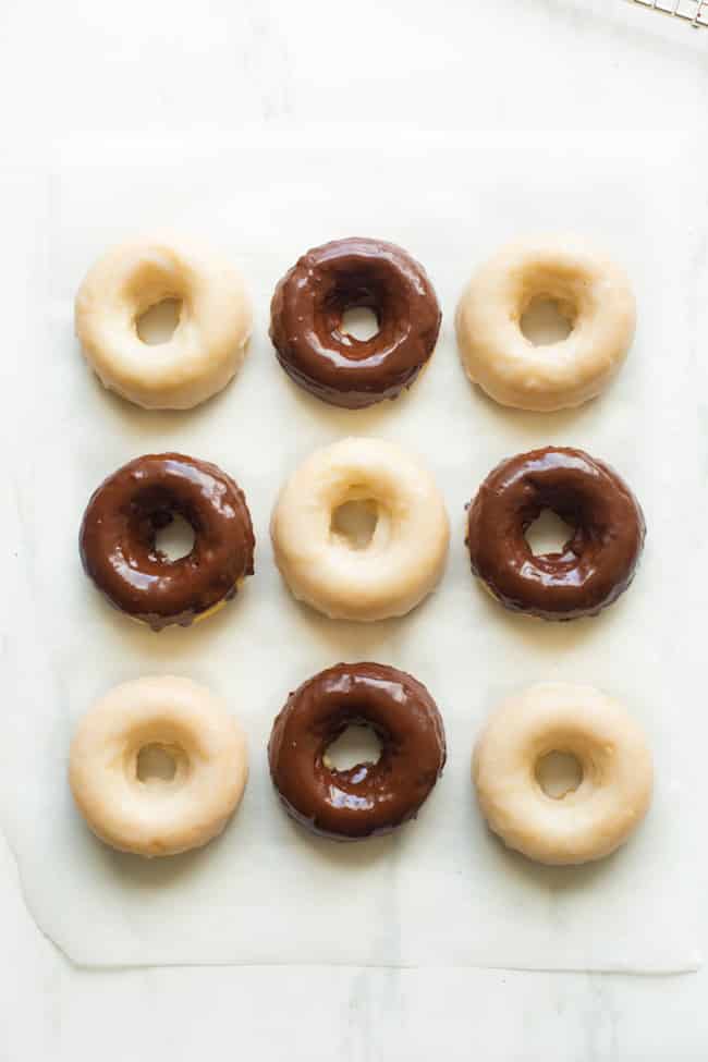 chocolate and vanilla gluten free donuts on baking paper