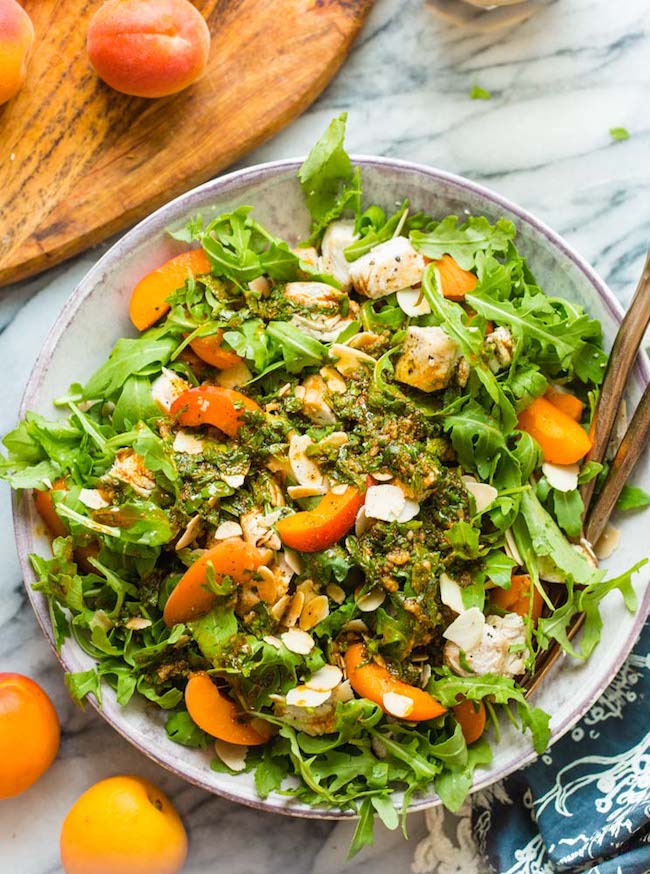 Almond & Apricot Chicken Salad topped with a cumin vinaigrette in a salad bowl