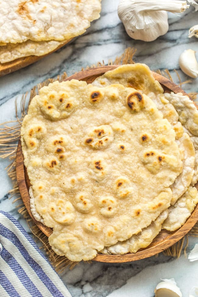 gluten free flatbread stacked on a wooden plate