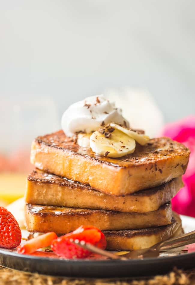 Gluten free french toast stack topped with bananas and whipped cream