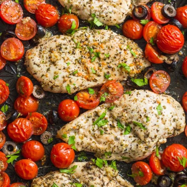 Italian Chicken with Cherry Tomatoes on a baking sheet