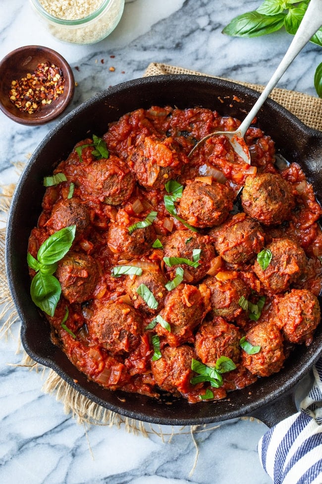 Vegan Lentil Meatballs in a cast iron skillet in marinara