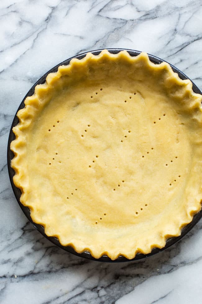 almond flour pie crust unbaked on a marble surface