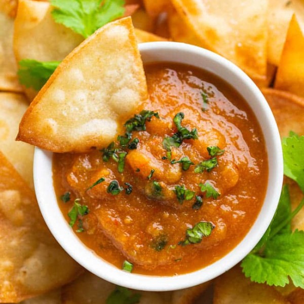 roasted chipotle salsa with a tortilla chip dipped in