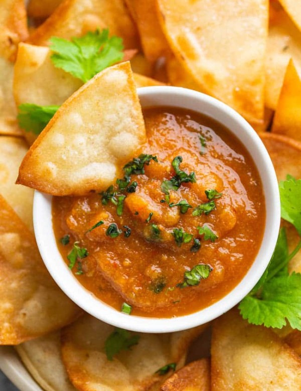 roasted chipotle salsa with a tortilla chip dipped in