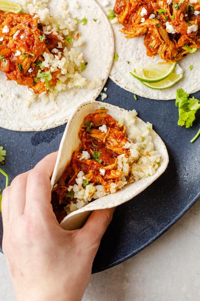 hand grabbing a chicken tinga taco