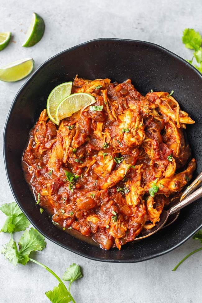 Instant Pot Chicken Tinga in a bowl topping with lime slices