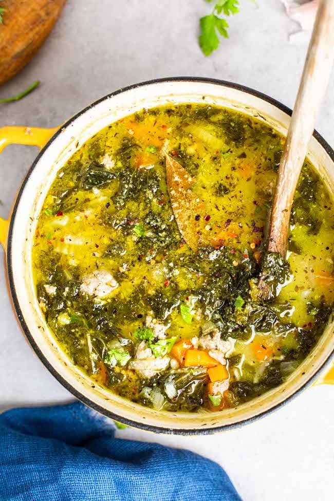 sausage kale soup in a yellow pot 