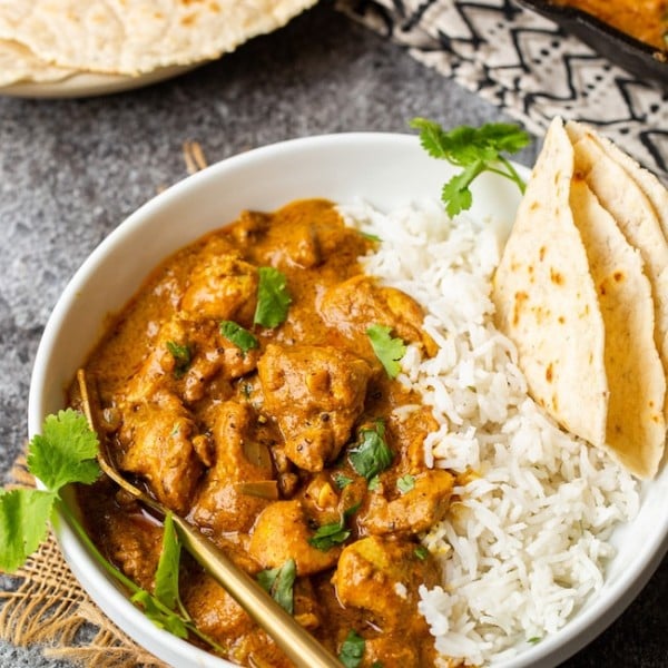 Butter Chicken Pumpkin Curry in a bowl with naan