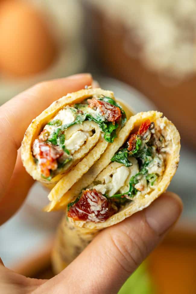 hands holding Low Carb Spinach Feta Egg Wraps 