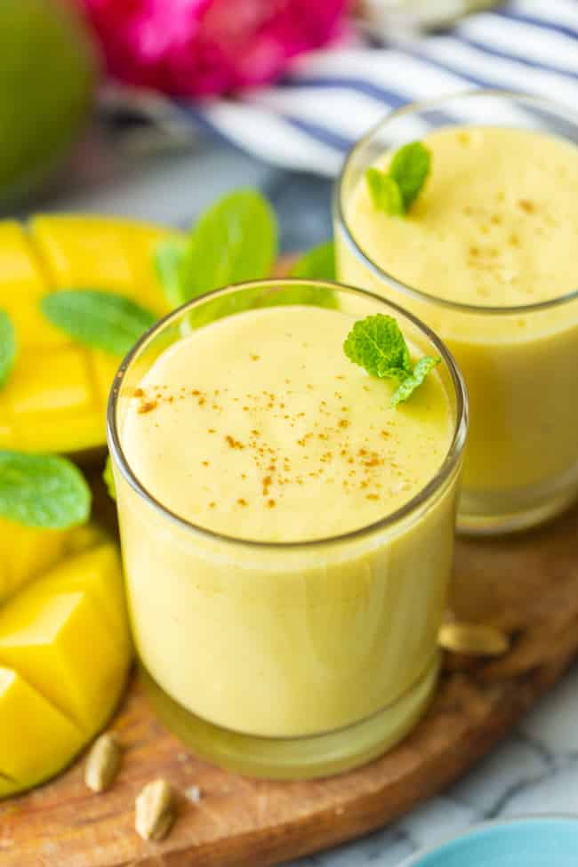 Mango lassi in a glass with mint