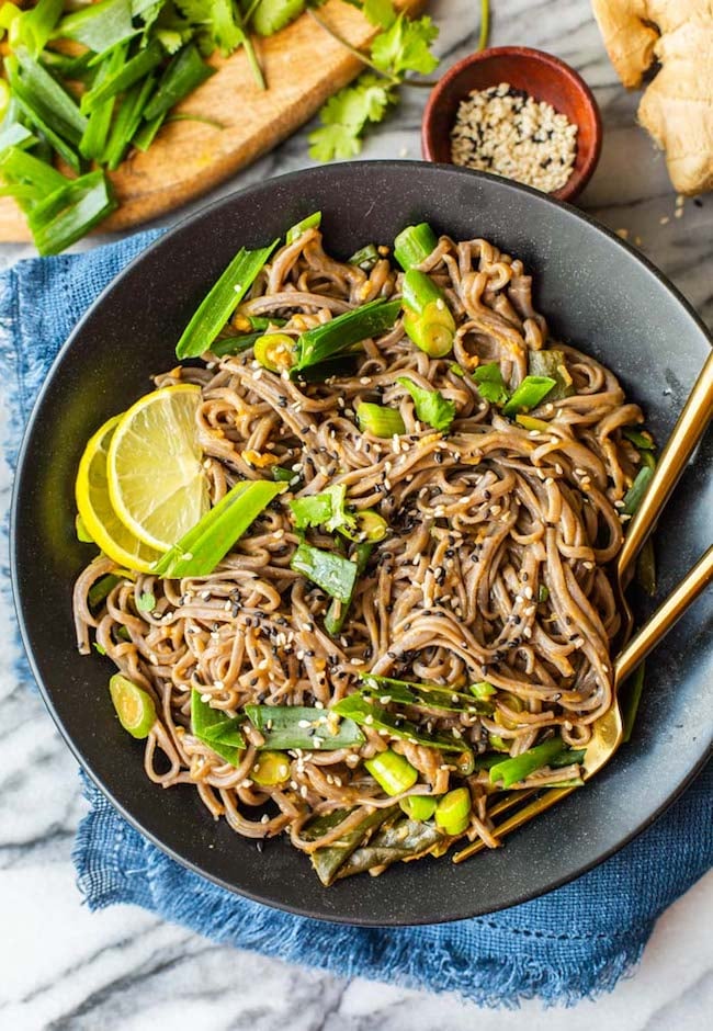 Spring Onion Peanut Noodles in a black bowl