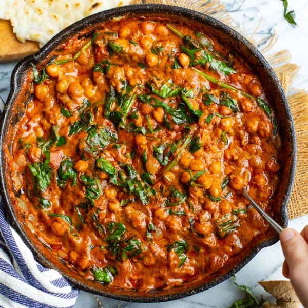 Tomato Basil Coconut Chickpea Curry in a cast iron skillet