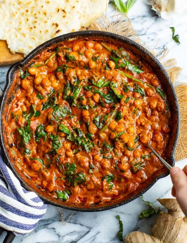 Tomato Basil Coconut Chickpea Curry in a cast iron skillet