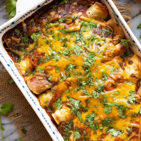 gluten free enchiladas topped with cheese and cilantro