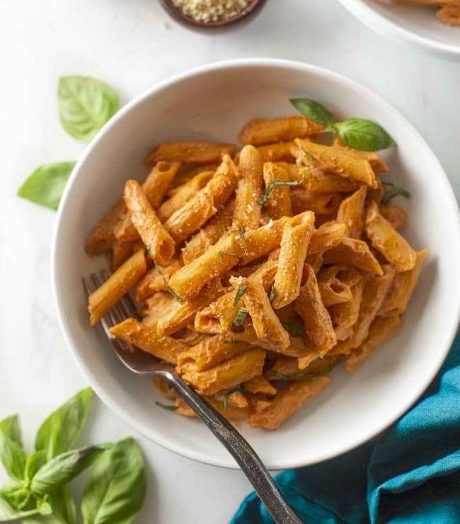 creamy cashew tomato pasta in a bowl