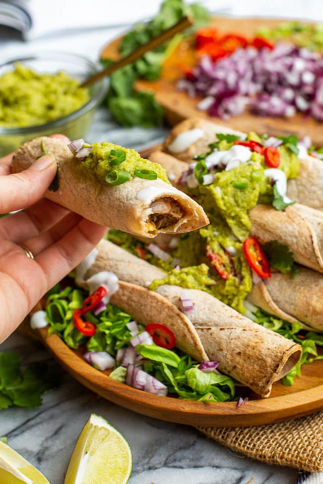 hand holding up Jackfruit Carnita Taquitos