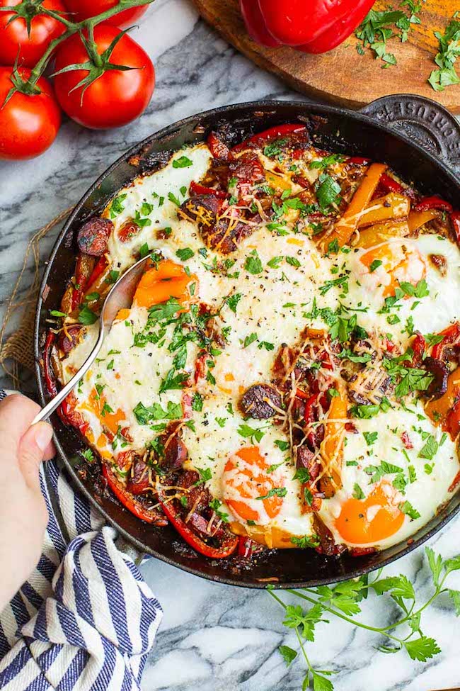 chorizo and baked eggs with peperonata in a skillet