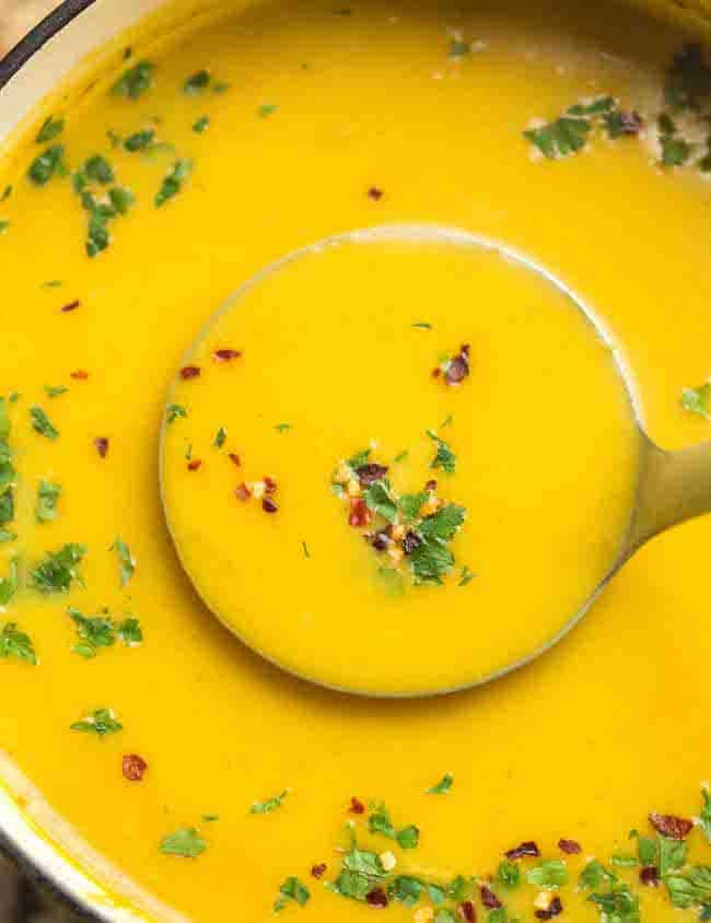 a soup ladle full of Curried Butternut Squash Soup 