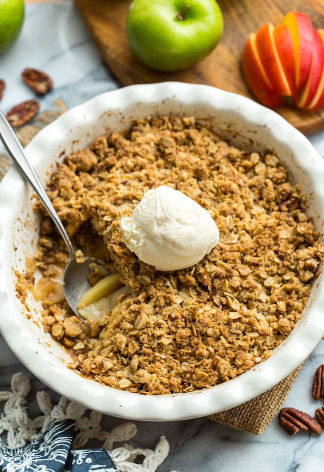 Gluten Free Apple Crisp in a baking dish with a spoonful scooped out. 