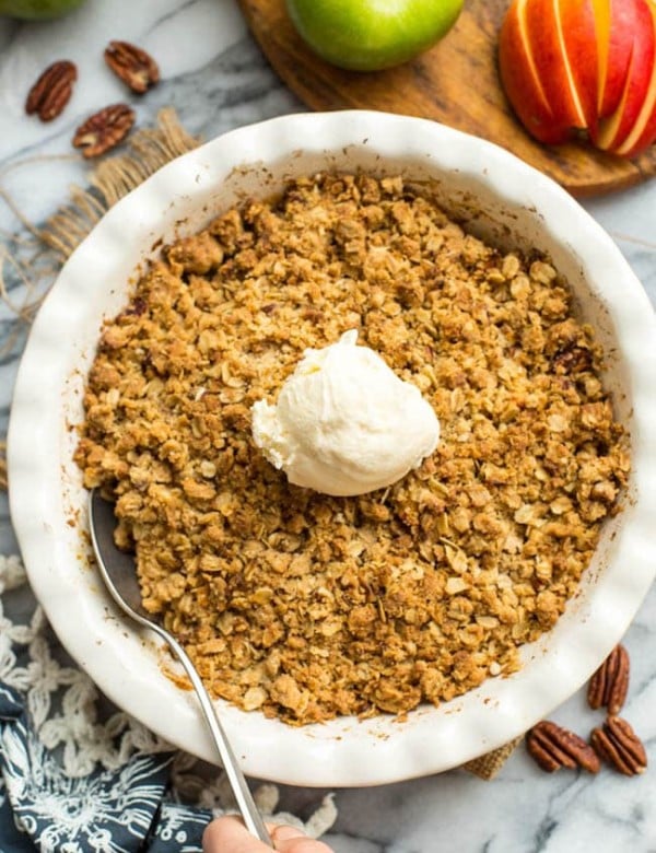 Gluten-Free-Apple-Crisp in a baking dish with ice cream