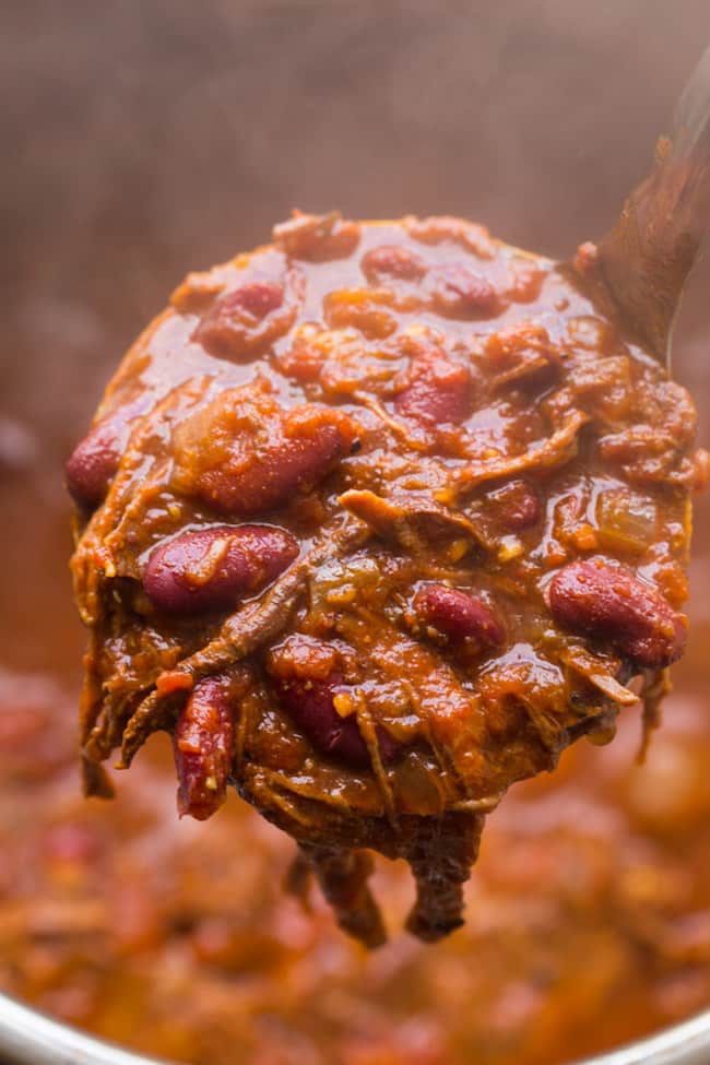 ladle full of Instant Pot Chili Con Carne with Shredded Beef