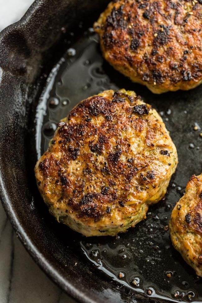 Broccoli Cheddar Chicken Burgers in a frying pan