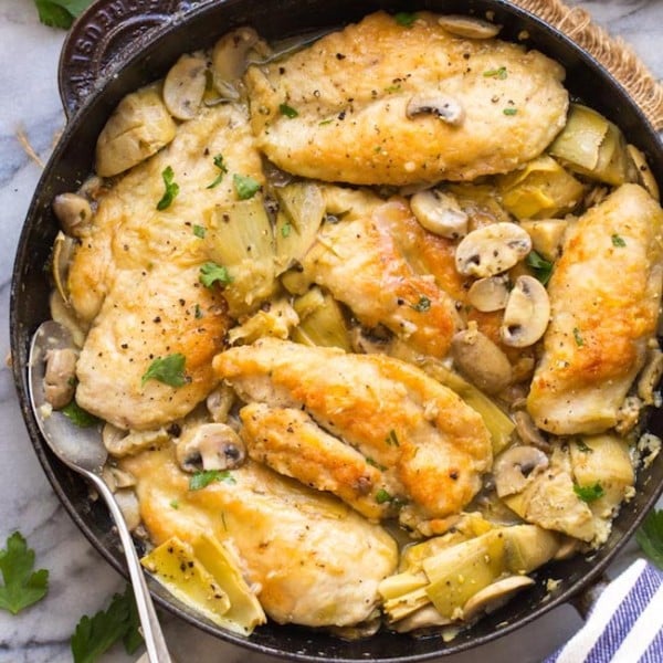 mushroom artichoke chicken in a cast iron skillet