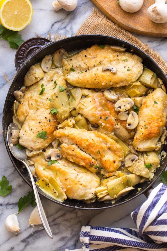 mushroom artichoke chicken in a cast iron skillet