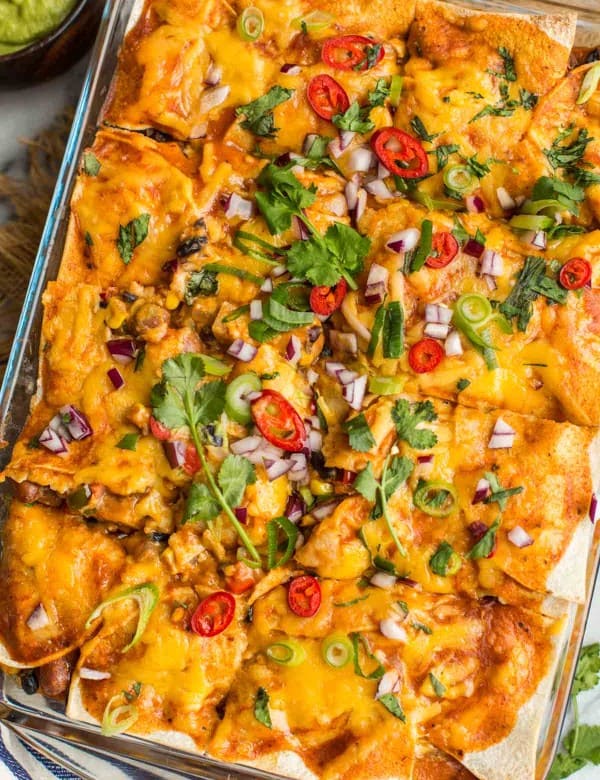 Black-Bean-Butternut-Squash-Enchilada-Casserole topped with cilantro, onion, and chilies